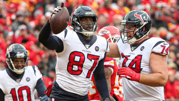 Houston Texans tight end Darren Fells is congratulated by tackle Max Scharping after scoring a touchdown against the Kansas City Chiefs during the first half in a AFC Divisional Round playoff football game at Arrowhead Stadium.